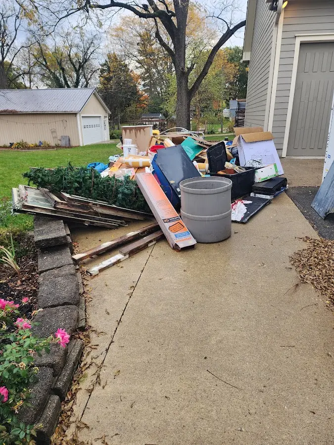 Dumpster being loaded with debris for Estate Cleanout Dumpster Rental in Kearny